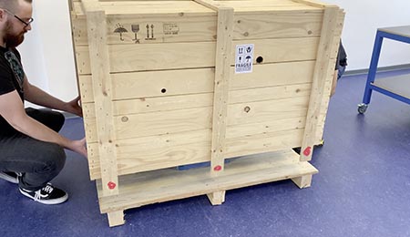 Lift the Lid onto the box for the Label Finishing System.