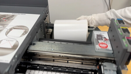 Remove the label roll and move the roll guide to the left.