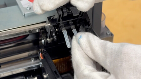 >Let’s cap the printhead side with the smaller transparent caps.